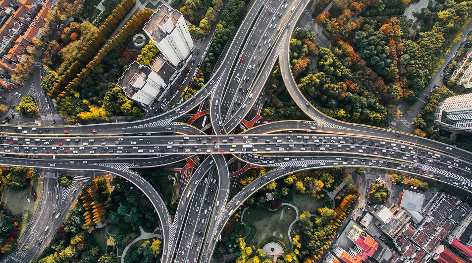 Aerial view of a busy multi-lane road interchange with heavy traffic