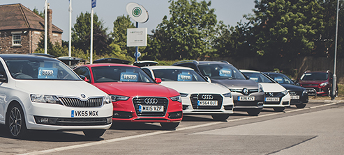 Cars for sale on a forecourt.