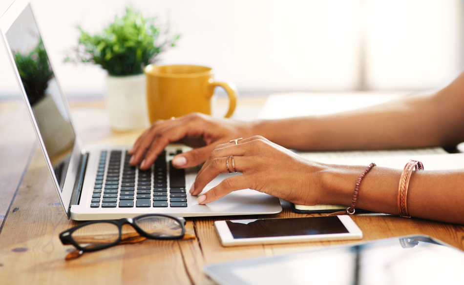 A consumer using a laptop at their desk