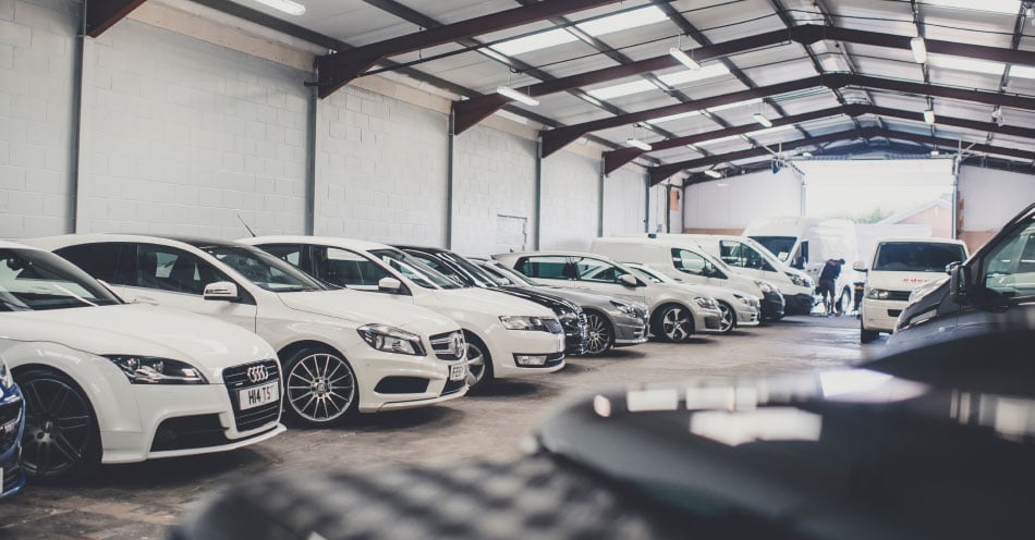 Help us identify key areas within your business where you would like to see improvement A vehicle showroom with cars and vans lined up